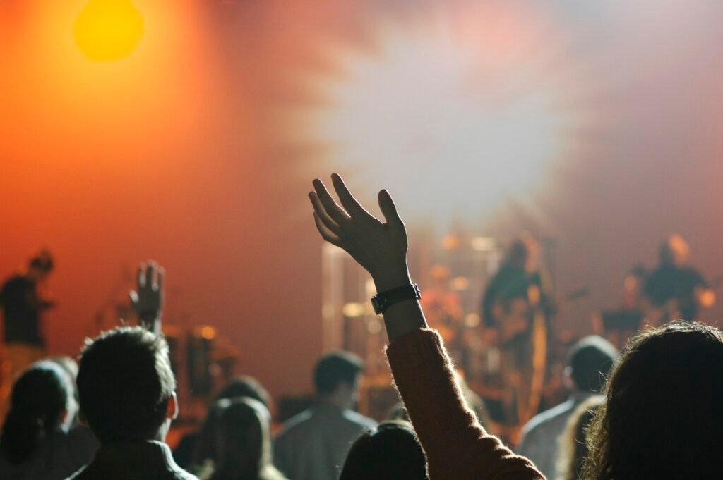 A worshipper raising a hand during worship
